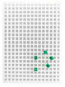 Top view of the 2.625mL square gummy mold with 266 cavities and translucent emerald green square gummies on a white background