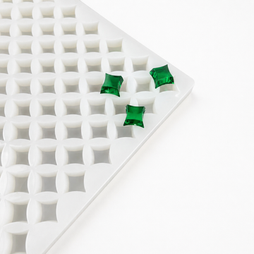 Close-up of a 2mL star gummy mold with 192 cavities and emerald green gummies on a white background