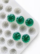 Angled product photo of a 3.1mL leaf gummy mold with 185 cavities and emerald green leaf gummies