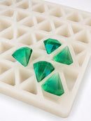 Close-up of a 3.5mL diamond gummy mold with 173 cavities and emerald green diamond gummies on a white background