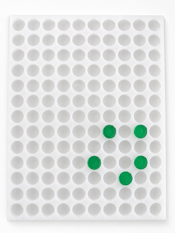 Top view of 3.8mL coin gummy mold with 130 round cavities and green gummies