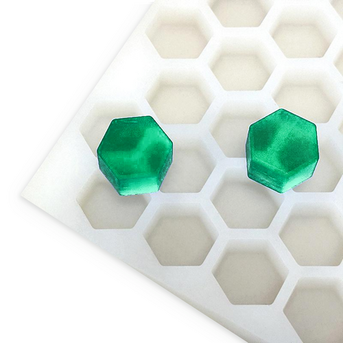 4.9mL hexagon gummy mold with 176 cavities and two emerald green hexagon gummies on a white background